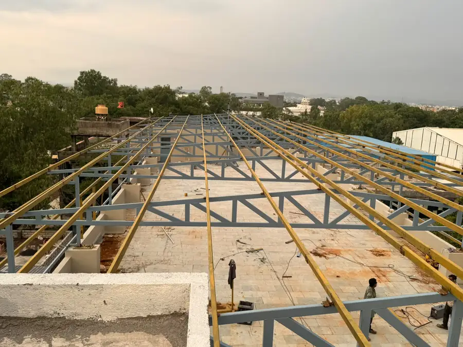 Steel purlins and roof framing being erected for an industrial shed in Nashik