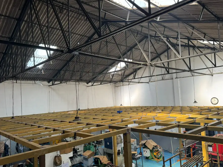 Mezzanine deck spanning an active workshop floor