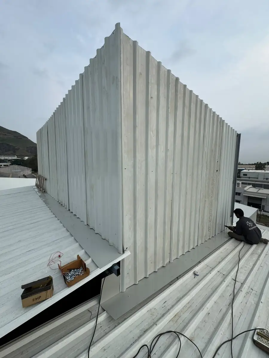 Wall cladding and profile sheeting being installed on a steel shed